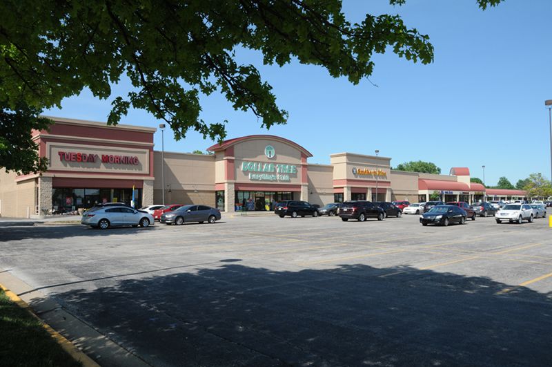 Stanley Square shopping center before redevelopment, showing the aging 1987 storefront facade and parking lot