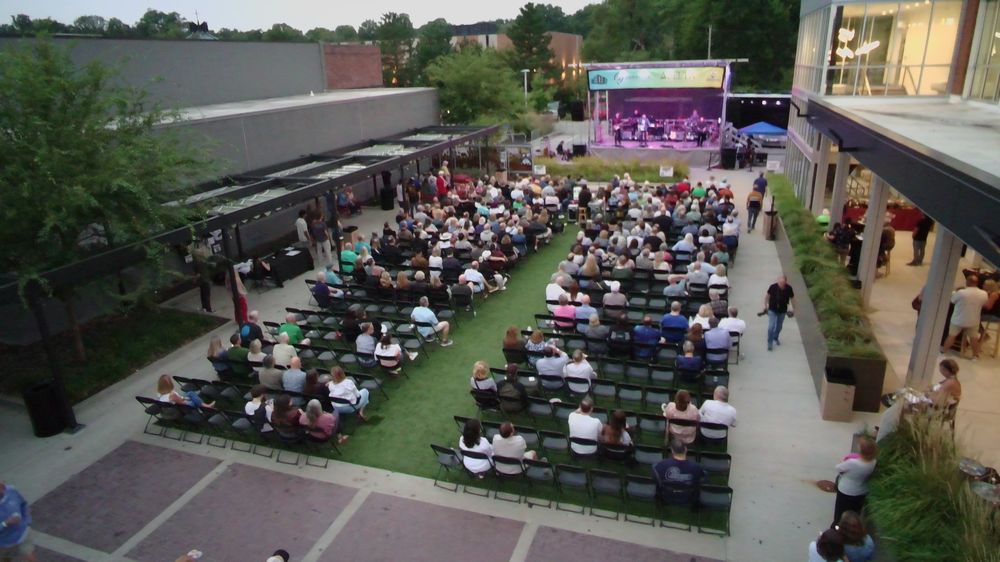Crowd seated for a national touring concert at The Yard, the community green space at Ranch Mart North